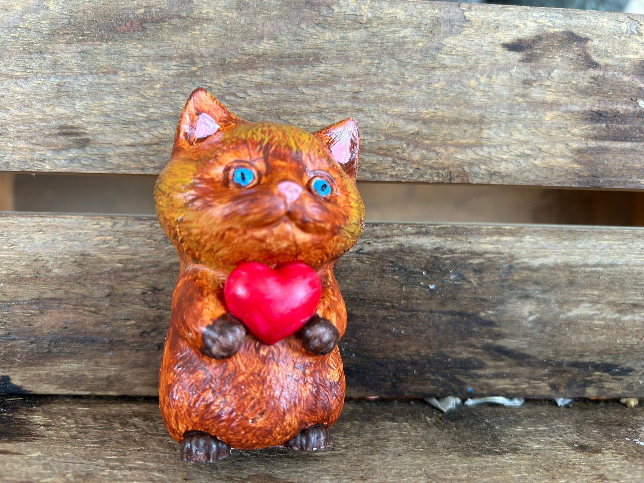 Cat holding heart
