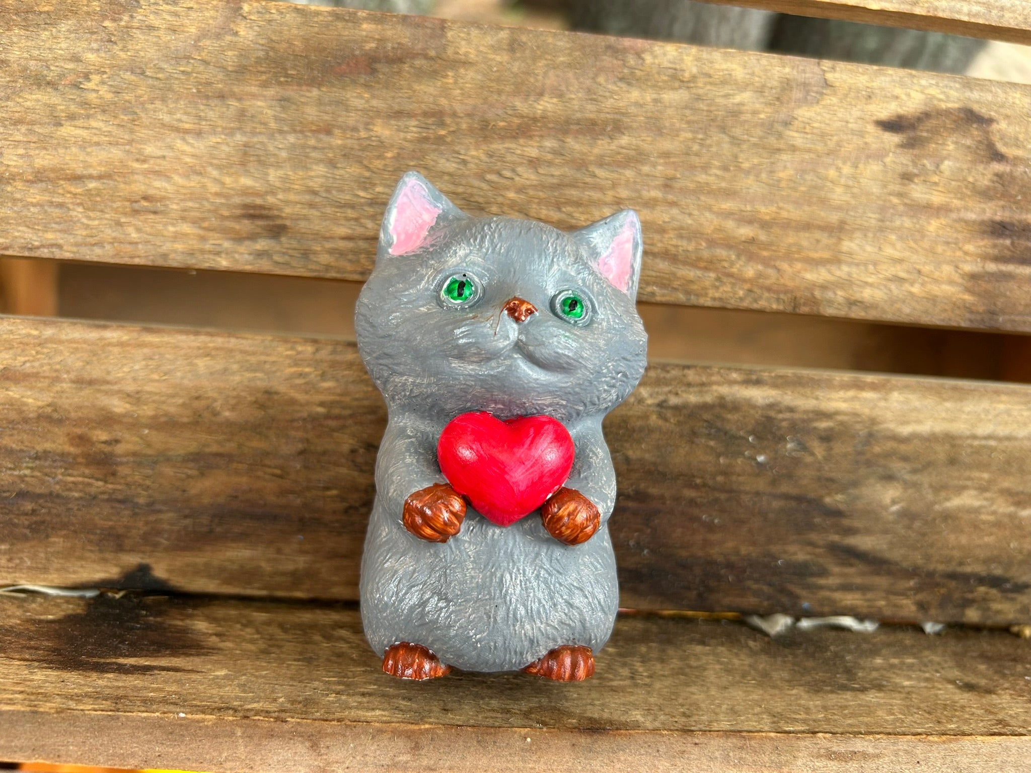 Cat holding heart